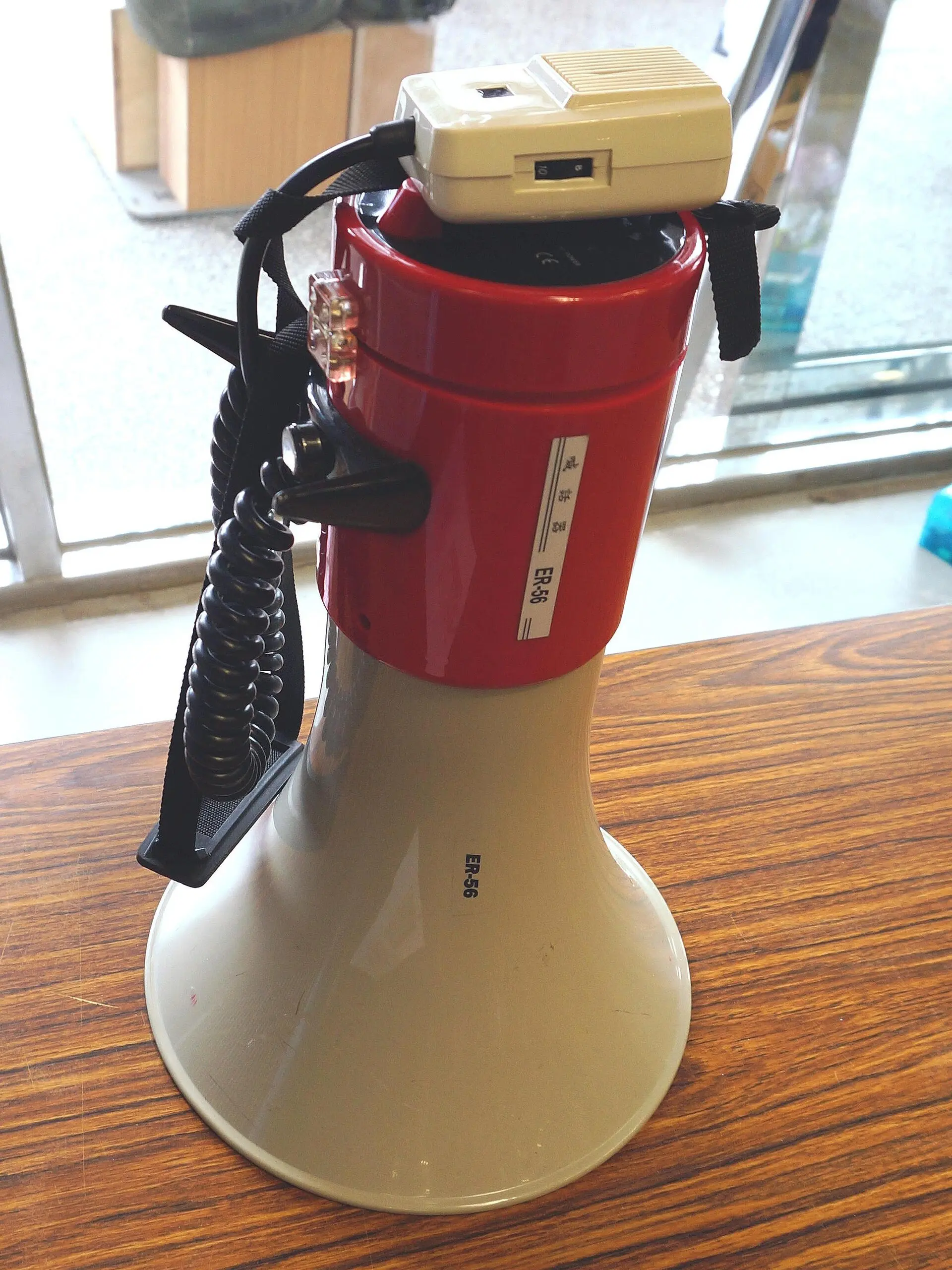 A red and white handheld megaphone on a table