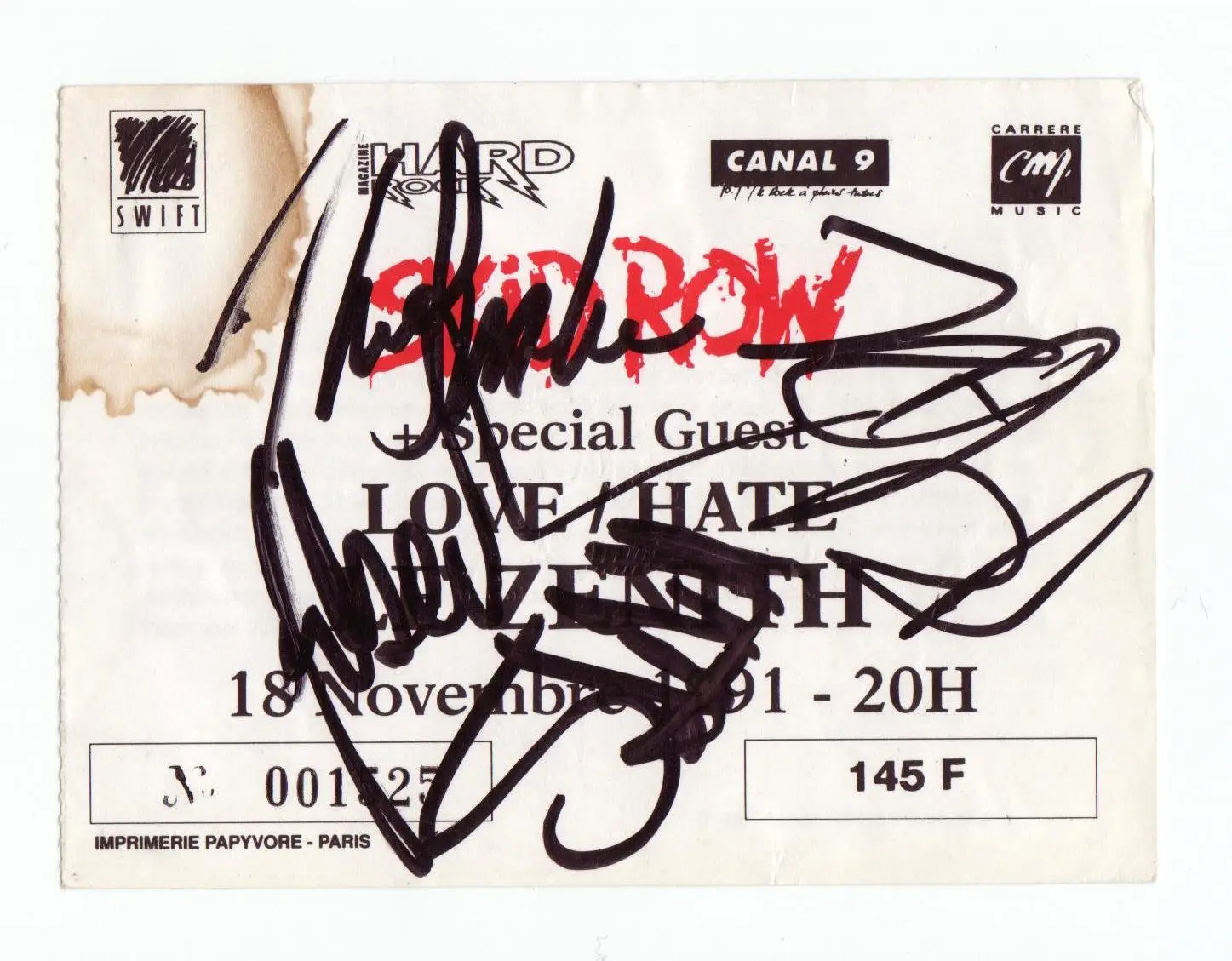 An old concert ticket stub covered in band members' autographs