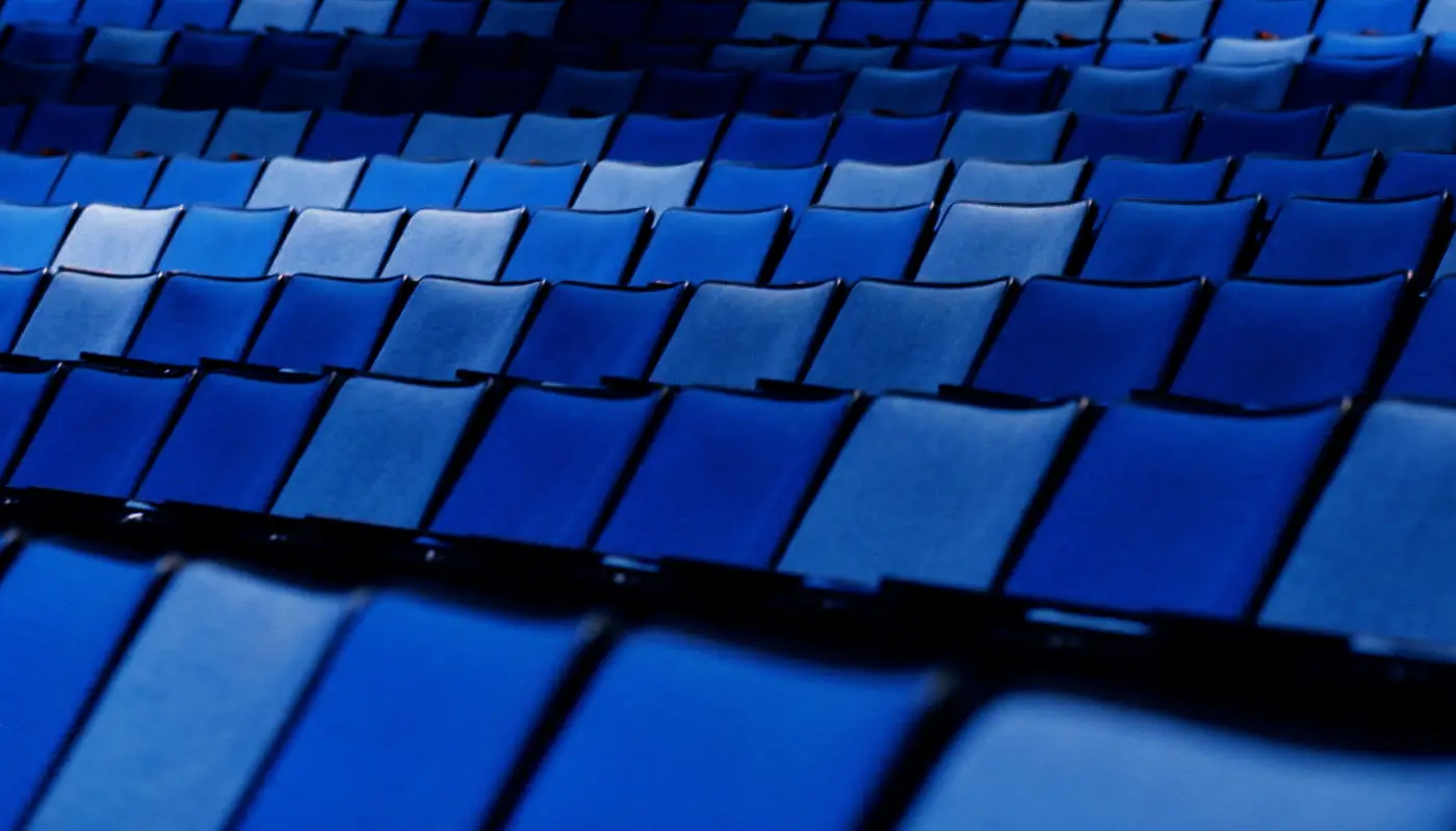 Rows of blue seats in an auditorium before a show